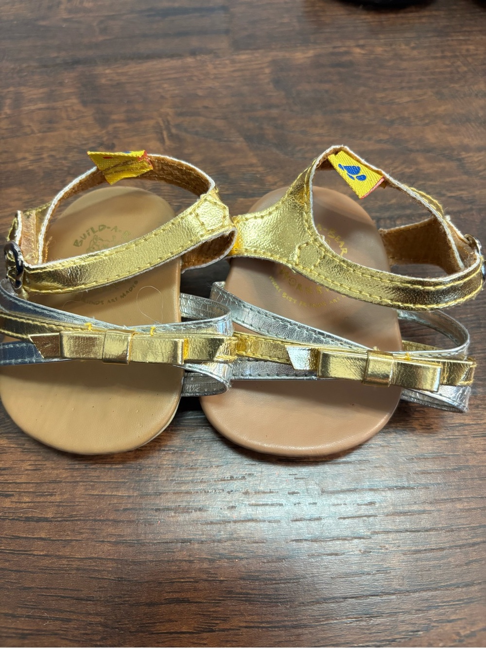 Build-A-Bear Workshop sandals feature metallic gold straps and silver accents